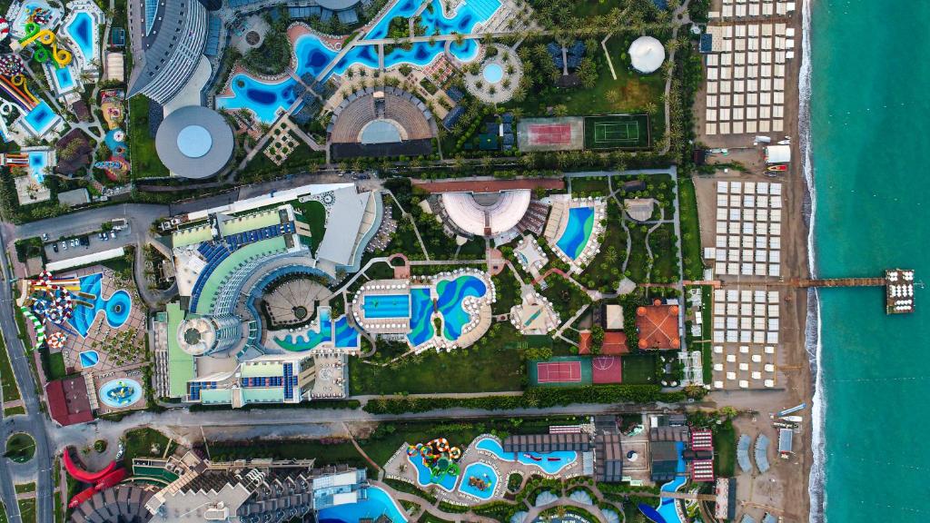 Arial view of Sherwood Exclusive Lara Resort in Antalya, showcasing its expansive pools, lush gardens, and beachfront location.