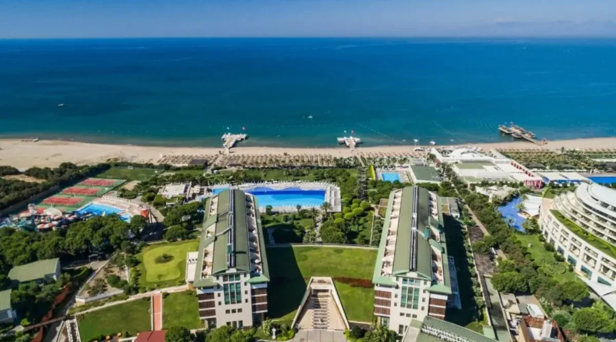 Stunning beachfront at Voyage Belek Golf & Spa with sun loungers and umbrellas