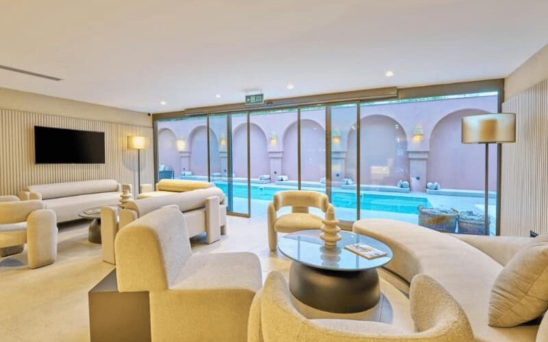 Modern lounge area with pool view at La Maja Hotel Antalya, featuring elegant seating, contemporary decor, and large glass windows