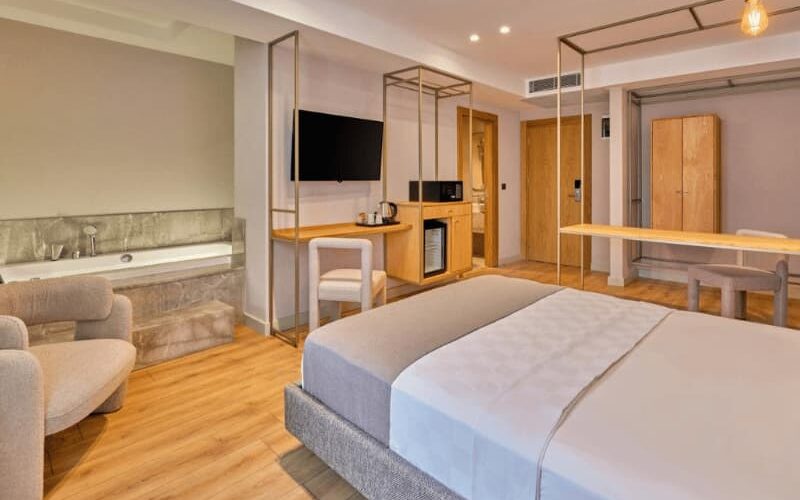 Spacious and stylish room at La Maja Hotel Antalya, featuring a comfortable bed, in-room spa bath, flat-screen TV, and modern furnishings