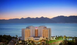 A panoramic view of Akra Hotel Antalya Lara, showcasing its beachfront location and luxurious amenities.