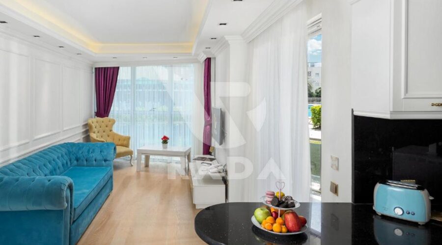 Modern living room with a fully equipped kitchen at Onkel Rada Apart Hotel, offering Antalya apartments for rent with luxury amenities and privacy