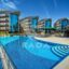 Onkel Rada Apart Hotel in Antalya with a large outdoor pool, perfect for families seeking an apartment for rent just 400 meters from the sea