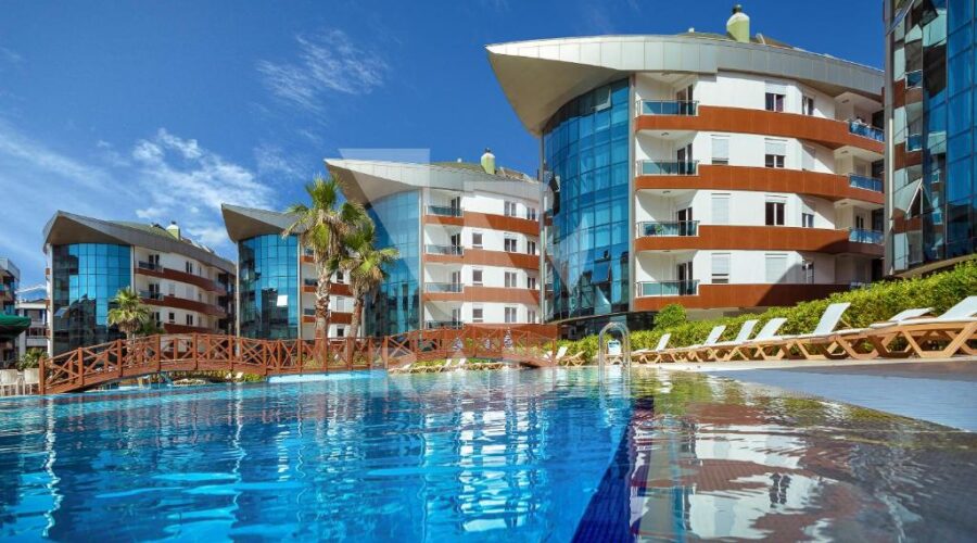 Onkel Rada Apart Hotel's modern architecture and outdoor pool, offering Antalya apartments for rent near the beach