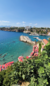 People enjoying the clear water at a beach and harbor in Antalya