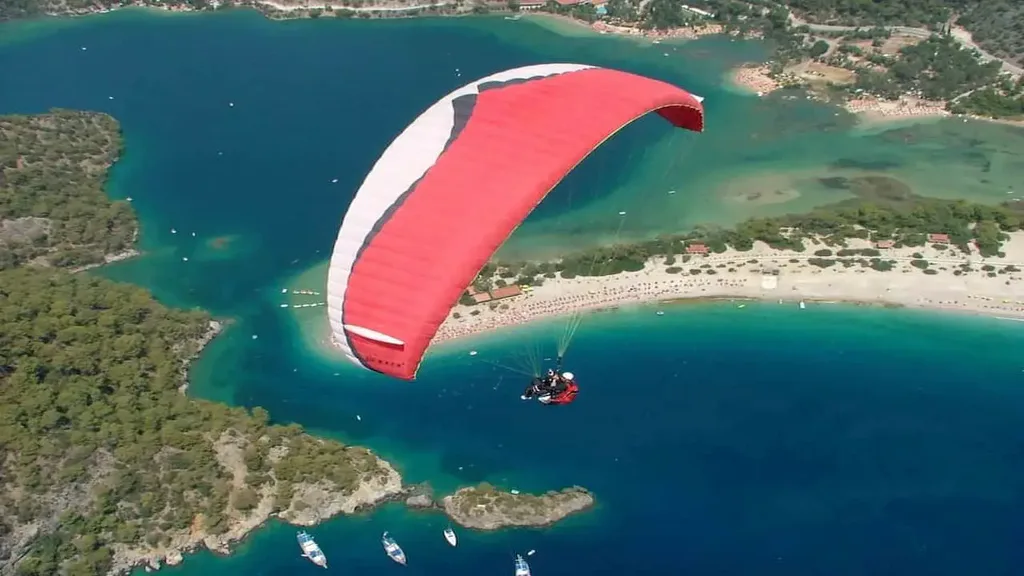 Oludeniz Paragliding Price view with a red and white paraglider over Ölüdeniz lagoon
